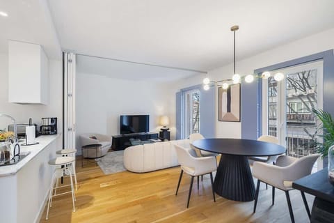 The dining area features a spacious table and chairs, perfect for enjoying meals together.  