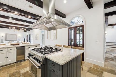 Cook like a chef in this stunning gourmet kitchen with professional-grade appliances, spacious granite island, and rustic beams overhead.