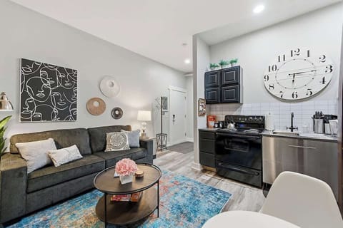 Bright open-layout living space with a comfy sofa and full kitchen for easy stays