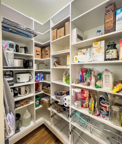 Walk-in Pantry is conveniently located next to the fridge.