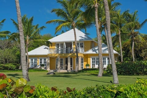 Arrive at a charming villa framed by swaying palms.