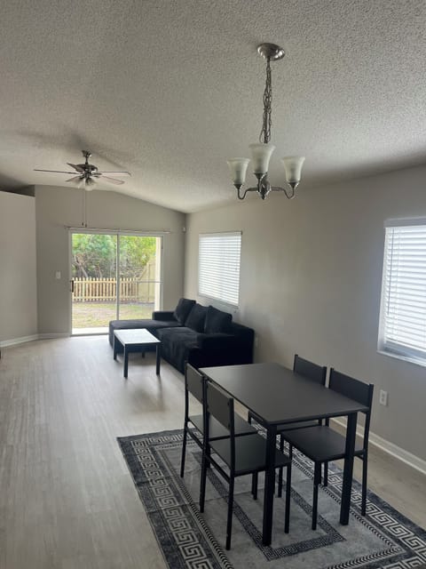 Bright living room with a comfy couch, coffe table, and TV for relaxing.