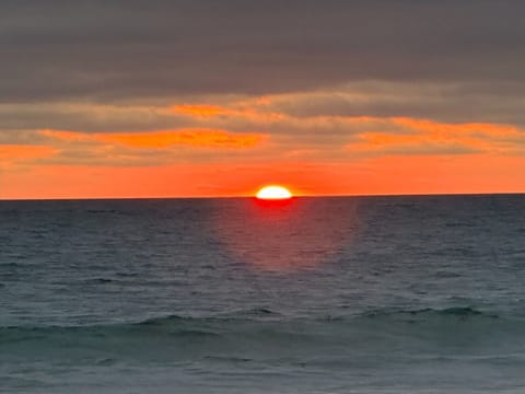 Gorgeous sunsets steps away from this near ocean front condo. 2 houses beach.