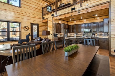 Host family meals in the open-concept dining area and gourmet kitchen featuring custom cabinetry and granite counters.