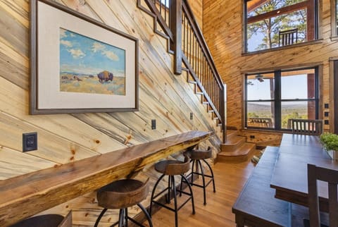 Enjoy your morning coffee at this stunning live-edge bar featuring convenient USB charging ports and unique diagonal wood-plank walls.