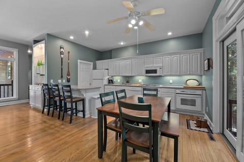 Bright and airy dining area with seating for large groups – perfect for family meals and gathering everyone together after a day on the lake.