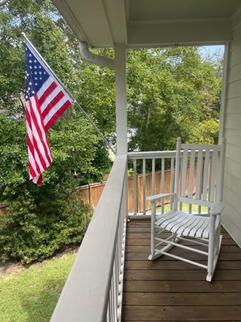 front porch has two rocking chairs and view of private driveway