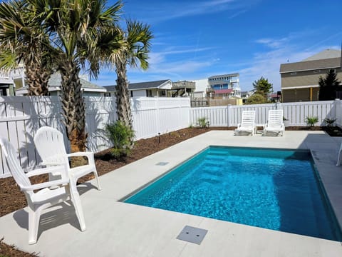 Dive into your private oasis with crystal-clear pool waters, tropical palms, and comfortable poolside loungers for perfect sunny days.