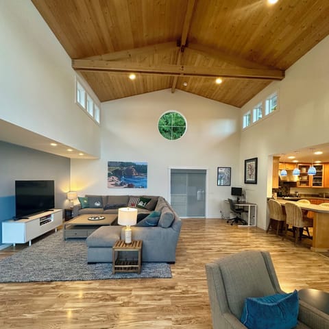 Tall ceilings, and lots of windows with comfy sofa sectional, TV and games.