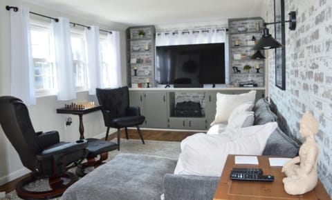 Den with 55 inch Fire TV and electric faux fireplace heater