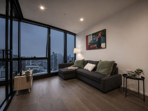 The living room sits beside a winter garden and is equipped with a smart TV and a sofa bed (setup available on request).