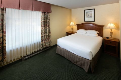 Wake up to soft daylight beside a cozy, inviting bed.