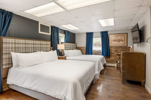 Unwind on crisp linens in a bright, spacious bedroom.