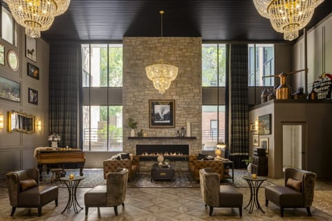 Unwind beneath sparkling chandeliers by the grand stone fireplace.