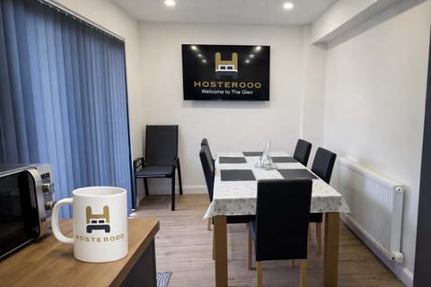 Modern dining area with TV - perfect for unwinding after work with comfortable seating for 6