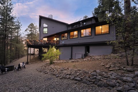 As the sun sets behind the pines, the cabin comes to life—warm lights, peaceful surroundings, and the perfect place to gather with the people who matter most.