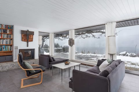 Bright living room with panoramic lake and mountain views