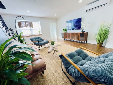 Comfortable living room with plush seating, 75" Smart TV, and fast Wifi.
