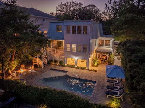 Private backyard retreat featuring a pool and sun loungers, perfect for relaxing or entertaining.
