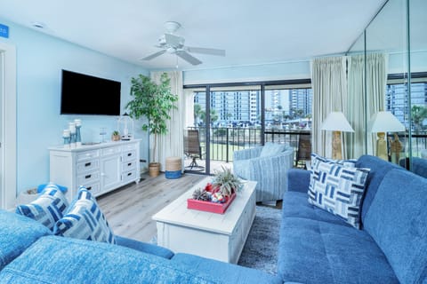 Bright, coastal living room with private balcony views