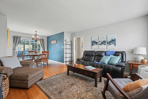 Living room with a TV, AC, heater, dining room, and lots of sunlight
