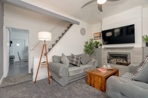 Unwind in the lounge with comfortable seating, TV, and a feature fireplace.
