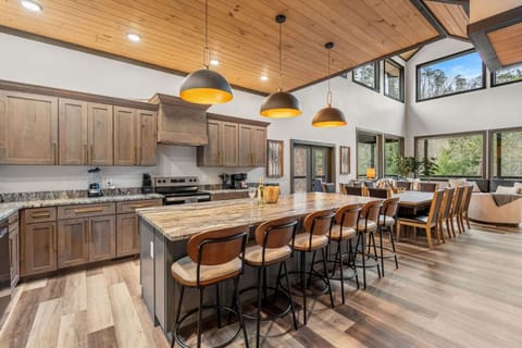The heart of the home—this chef’s kitchen features a massive island with seating for 7, granite counters, and rustic-modern charm that brings everyone together.