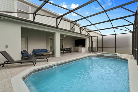 Step into a sunlit oasis featuring a refreshing pool surrounded by sleek lounge chairs, perfect for unwinding after a day of adventure. The modern canopy allows for outdoor enjoyment while providing a sense of privacy and comfort.