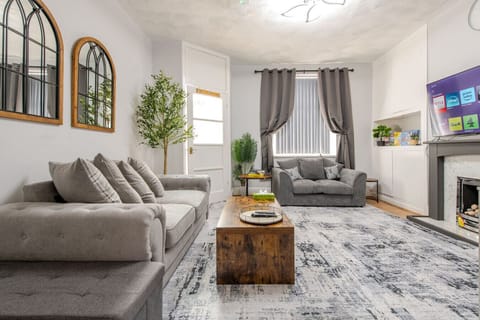 Relax in the lounge with two sofas, a coffee table, and a fireplace.