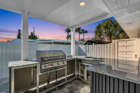 Outdoor Area - spacious kitchen space with grill, kitchen sink, mini fridge.