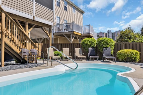 Sunny backyard pool area with spacious lounge deck