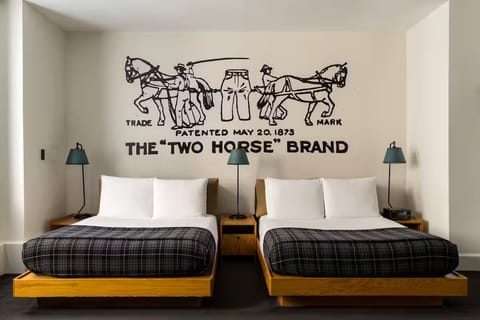 Settle into two plush beds beneath bold, iconic wall art.