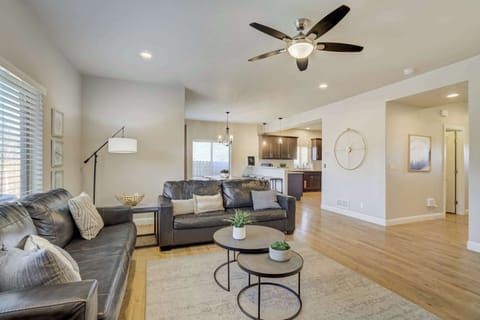 This open-concept main level creates a bright environment for relaxation. Large windows and overhead fans keep the space airy, while the layout connects the living room directly to the dining area for seamless flow.
