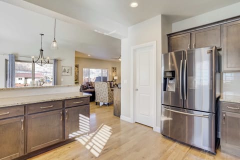 The kitchen features granite surfaces and professional-grade stainless steel appliances. This fully stocked kitchen includes a complimentary coffee station with pods, ensuring you have everything needed for a morning brew.