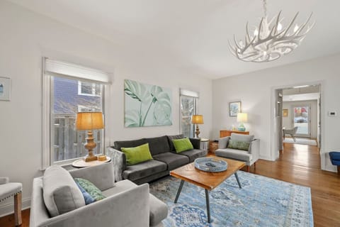 Bright and airy living room with cozy seating, warm lighting, and plenty of space to relax together after a day out.