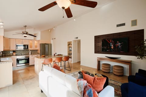Main living area featuring cozy furnishings, a Smart TV, and access to the backyard.