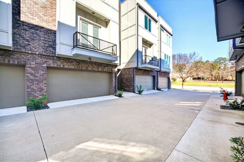 Modern townhouse exterior with attached garage and bright private drive
