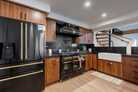 Cook memorable meals in your fully equipped kitchen with premium appliances, rich wood cabinetry, and elegant granite countertops.