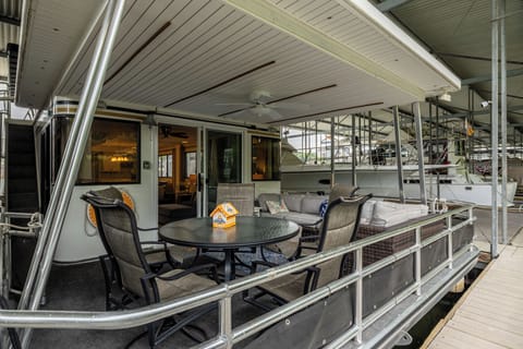 Step onto the dock and there she is — your own two-story houseboat, tucked into 
