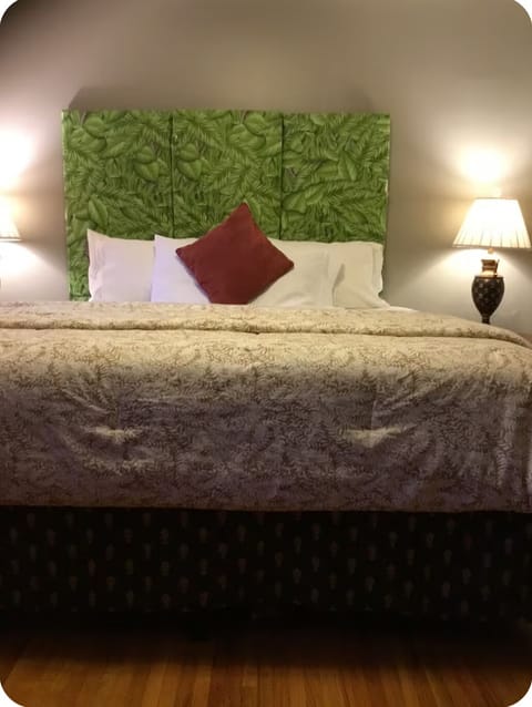 Bedroom #1 with King Bed, TV, chest, nightstands, lamps, chair