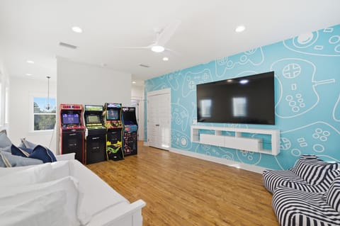 Kids’ bonus room with arcade games and 85 inch TV for downtime and play
