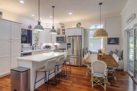 Guests can cozy at the kitchen island or visit from the adjacent dining areas.