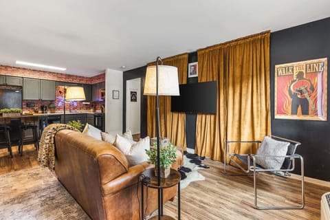 Cozy living room with a smart TV and a sleeper sofa. Opens up into the kitchen. No stairs in this condo and located on the ground level, for easy access.