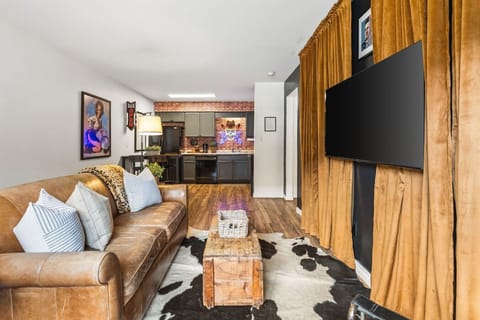 Cozy living room with a smart TV and a sleeper sofa. Opens up into the kitchen. No stairs in this condo and located on the ground level, for easy access.