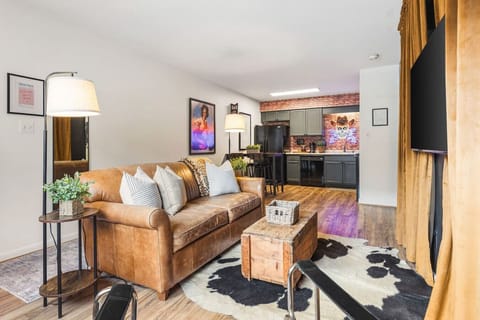 Cozy living room with a smart TV and a sleeper sofa. Opens up into the kitchen. No stairs in this condo and located on the ground level, for easy access.