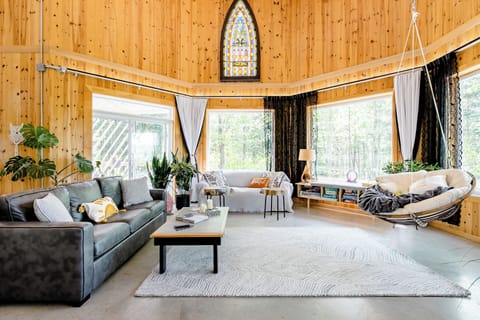 Floating chair with forest, mountain views. 19' ceiling & antique stained glass.