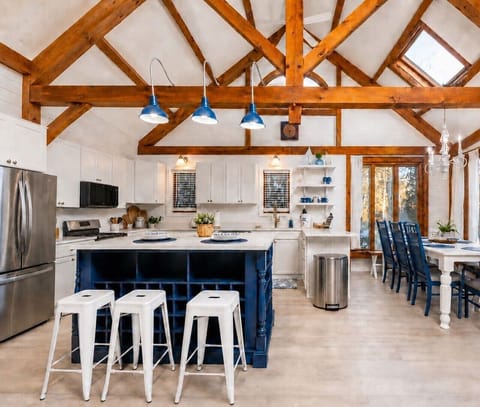 The heart of the home. A stunning kitchen with soaring ceilings, exposed beams, and generous island seating. The space is perfect for group meals, morning coffee, and gathering everyone together.