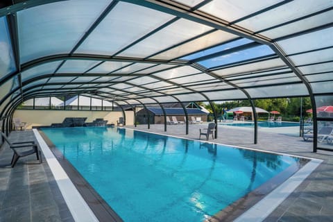 Enjoy year-round swimming in this spacious, indoor-outdoor pool, perfectly surrounded by the beauty of nature at Camping La Citadelle.