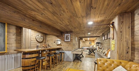 The lounge and bar invite everyone to gather, play games, and unwind in a warm, cozy atmosphere.