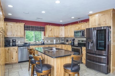 The kitchen is large and fully stocked with views to the lake while cooking